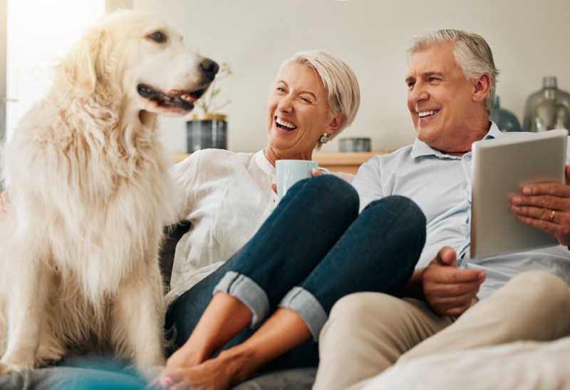 Dog, relax and senior couple laughing