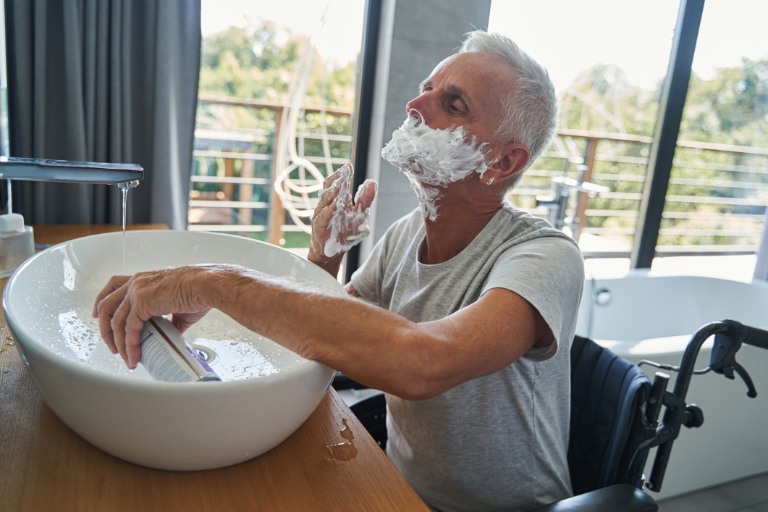 applying shaving cream on his face
